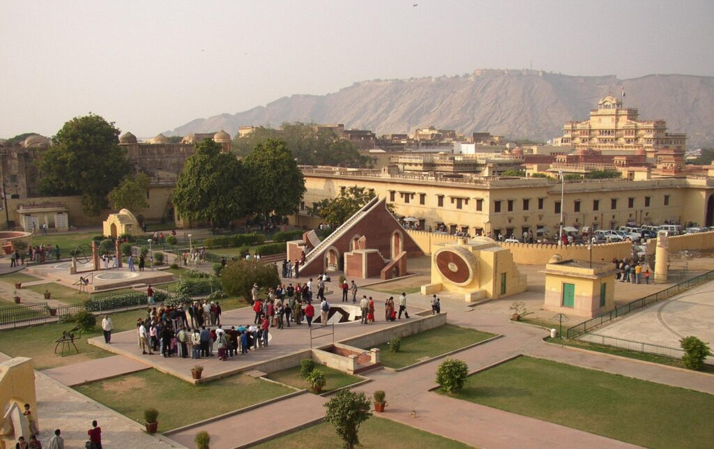 Aerial view of Jantar Mantar in Jaipur showcasing historic astronomical instruments, open courtyards, and visitors exploring the UNESCO World Heritage Site.
